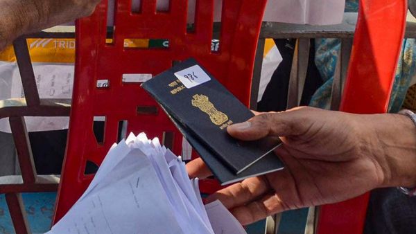 Indian passport and Aadhaar card documents on table