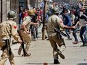 Indian Army in Kashmir fighting people shouting ‘go back Indian dogs’ slogan