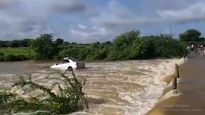Watch: Passengers in the nick of time as car gets washed away in overflowing water in AP