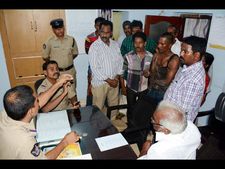 జేసీబీపై కార్మికుడు: పోలీసులు కిందకు ఈడ్చారు, తల పగిలింది (ఫోటోలు)