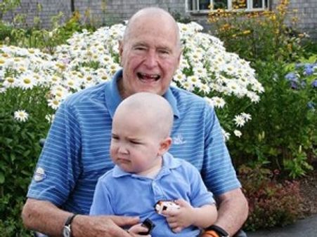 Bush Sr shaves head to show solidarity with sick child