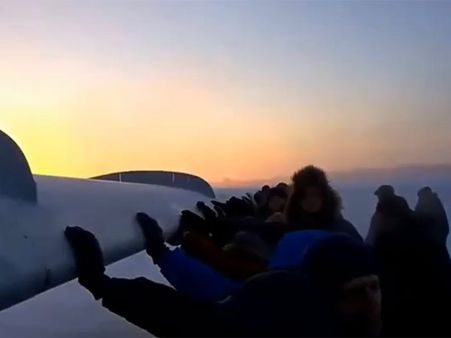 Plane freezes to ground in Russia; passengers push it to runway