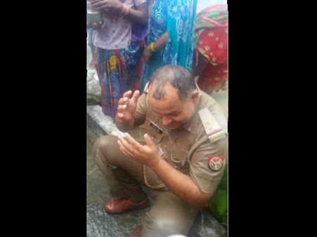 Bizarre tradition: Cop bathed by women for appeasing rain gods!