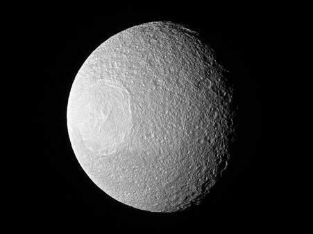 Saturn's icy moon looks like a giant golf ball in space!