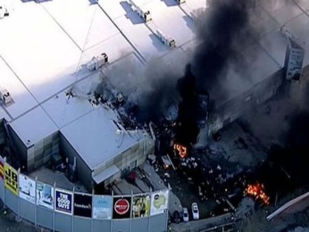 Five feared dead after plane crashes into into shopping centre near Melbourne