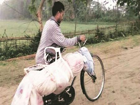 No motorable roads in Assam CM’s constituency Majuli; man carries dead brother on bicycle