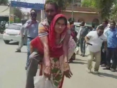 Sad but true: Woman carries husband on her back to get disability certificate