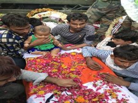 This infant sitting on her martyred father’s coffin will move you to tears