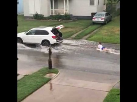 This woman knows how to play water sport in flooded streets… Are you game?