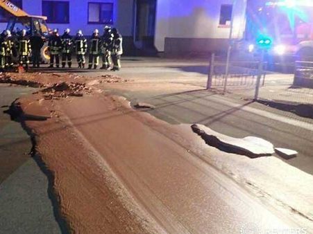 Yummy menace! Chocolate overflows from factory storage onto street in Germany town