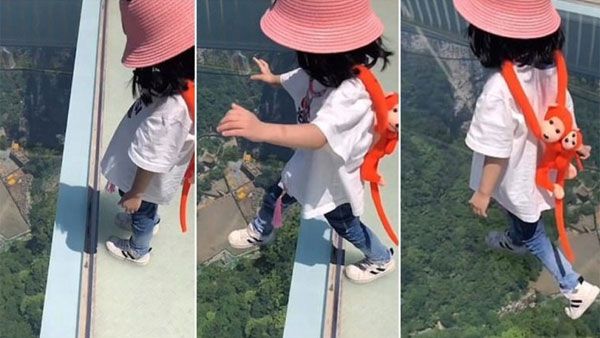 This 3-year-old baby girl walks onto China's terrifying glass bridge 870ft above the ground
