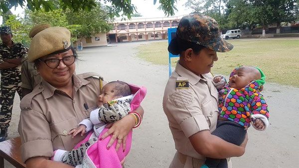 This pic of Assam cops holding babies while their mom write TET exam, wins internet