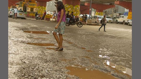 A unique way to highlight potholes in B'luru: Turn them into photo ops and embarrass the authorities
