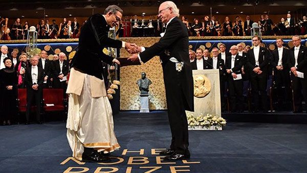 Abhijit Banerjee, wife Duflo draped in Dhoti and Sari receive medals of Nobel Prize