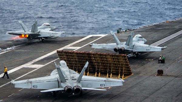 Tensions soar as US destroyer sails near disputed islands in South China Sea