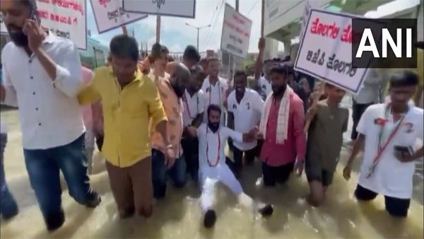 Demanding solution, Cong leader floats on rubber tube on waterlogged Bengaluru road [Video]