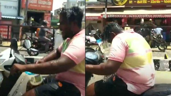 ப்பா..என்னா வெயிலு.. பைக் ஓட்டிய படியே இதமாக சாலையில் குளியல் போட்ட தஞ்சை இளைஞர்.. தூக்கிய போலீஸ்