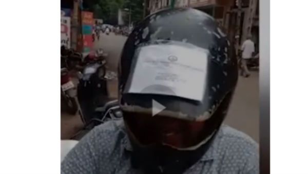 ఇప్పుడు ఎలా పట్టుకుంటారు... హెల్మట్ చుట్టు ఆర్సీ,డ్రైవింగ్ లైసెన్స్, ఇతర పత్రాలు అంటించిన వ్యక్తి...