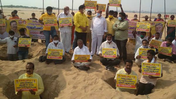 కృష్ణానది రక్షణ గోడపై టీడీపీ విన్నూత్న నిరసన- నదిలో తవ్విన గోతుల్లో నిల్చుని...కృష్ణానది రక్షణ గోడపై