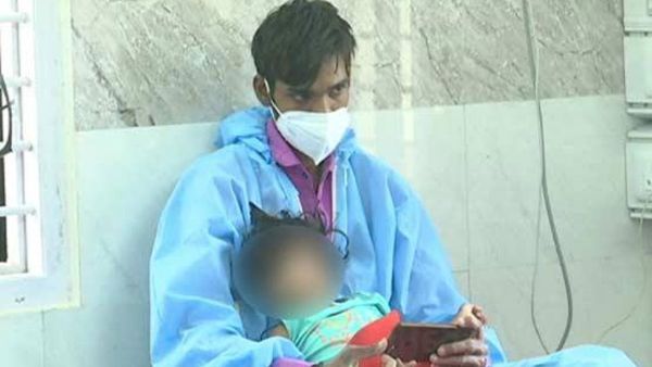 ఇదీ పరిస్థితి.. చిన్నారితో కలిసి తండ్రి, పీపీఈ కిట్ ధరించి మరీ