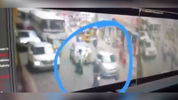 కారు ఆపమన్నందుకు హోంగార్డుపైకే దూసుకెళ్లాడు (వీడియో)