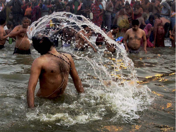 संगम में स्‍नान करता साधु