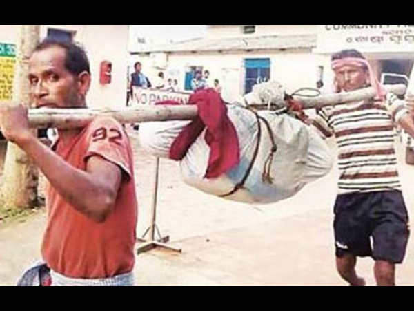 Woman's body broken at hip, slung on bamboo pole Woman's body broken at hip, slung on bamboo pole