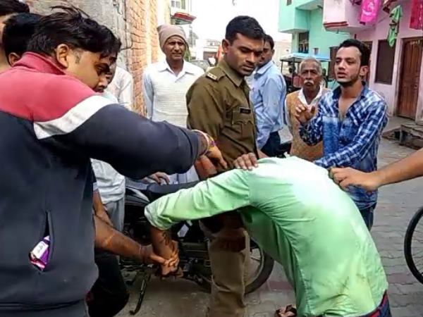 Two youth beaten by police and public for molesting a girl in Hapur, Uttar Pradesh.