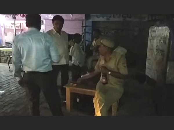 Policemen drinking wine in public place in Kannauj