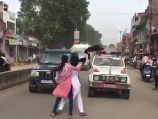 Amit Shah has two girls showing black flags in Allahabad Amit Shah has two girls showing black flags in Allahabad