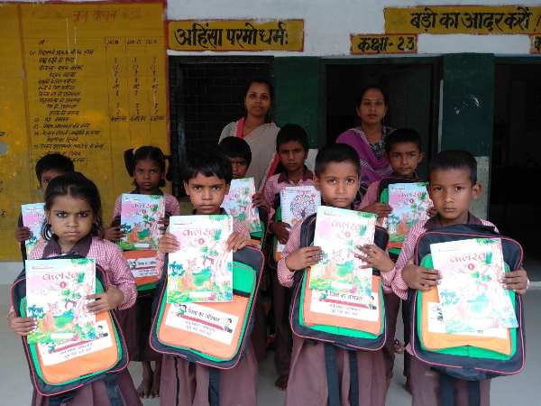 lucknow cm yogi distributed bjp flag like colour bag to primary students