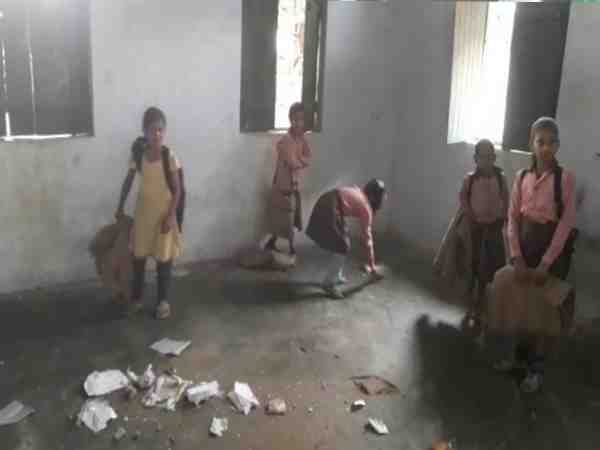 small children cleaning classroom with broom in farrukhabad school