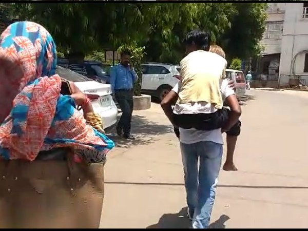 father carry his son on his back for treatment in hospital