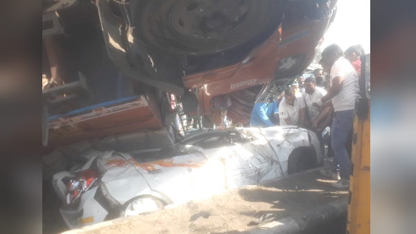 in Gujarat, 10-wheeler truck overturns on car, but driver Miraculously escape in Gujarat, 10-wheeler truck overturns on car, but driver Miraculously escape