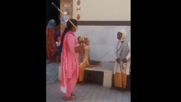 Hanumangarh Parshad Poonam beat up to sadhus for mask video goes viral Hanumangarh Parshad Poonam beat up to sadhus for mask video goes viral