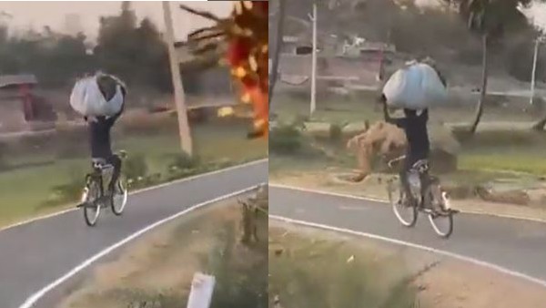 हाथों से पकड़ी गठरी और चला रहा साइकिल 