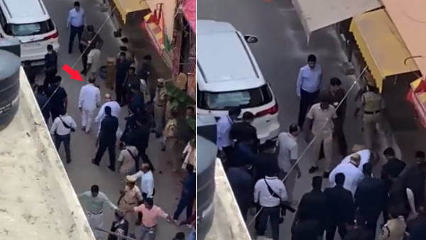 Telangana BJP chief Bandi Sanjay rushing to fetch footwear of Amit Shah viral on social media Telangana BJP chief Bandi Sanjay rushing to fetch footwear of Amit Shah viral on social media