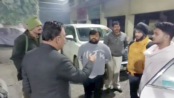 Saharanpur on duty tax collector caught drinking liquor with junior by MLA toching feet apologising Saharanpur on duty tax collector caught drinking liquor with junior by MLA toching feet apologising