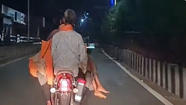 carrying daughters body on bike 