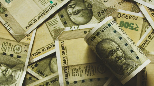 Man throwing cash on people 