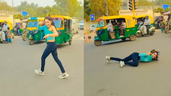 girl dancing in between heavy traffic