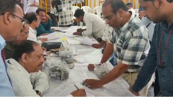 Candidate filling Lok Sabha form with coins Candidate filling Lok Sabha form with coins