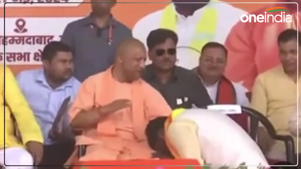 ghosi-lok-sabha-election-2024-arvind-touched-cm-yogis-feet-while-sitting-on-the-floor