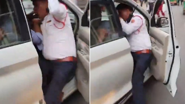 Traffic Policeman dragged into speeding vehicle