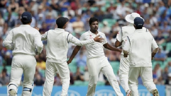 Varun Aaron center celebrates with team mates