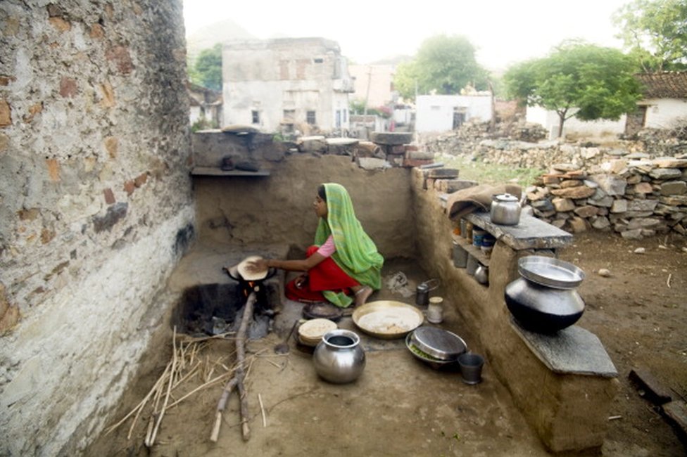 रोटी पकाती एक भारतीय गृहिणी
