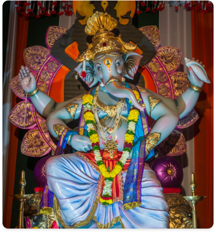 A garlanded Ganesh idol enthroned in a pandal