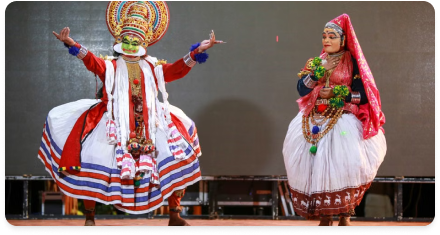 Two folk dancers performing in traditional costume