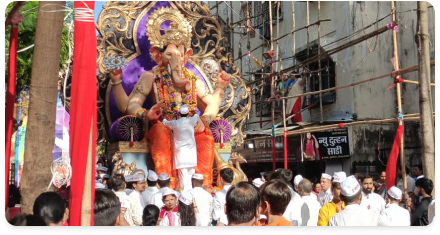 A Ganesh idol carried along a street in procession
