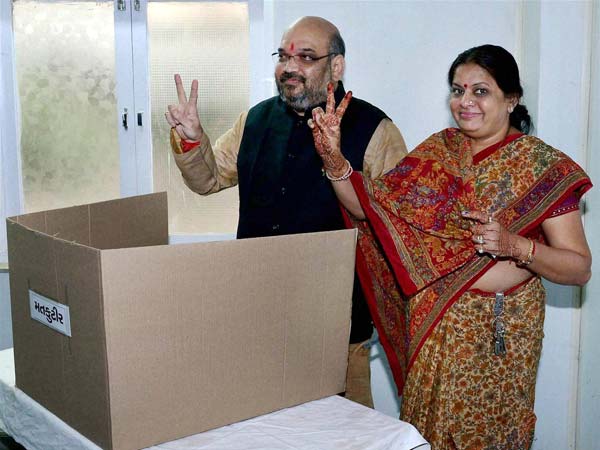 Amit Shah and his wife flash the victory sign Amit Shah and his wife flash the victory sign